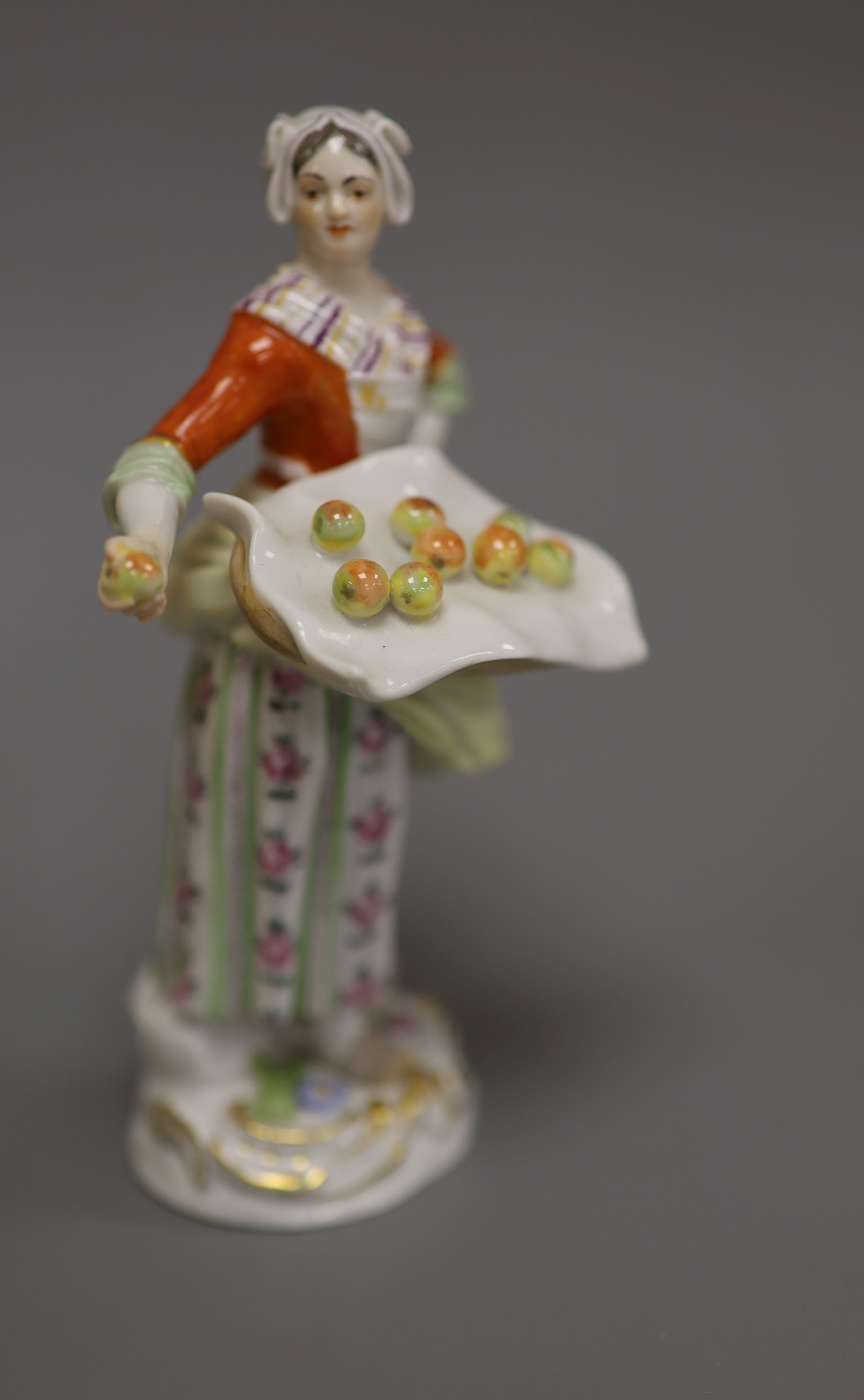 A late Meissen porcelain figure of a girl selling apples, H 14cm